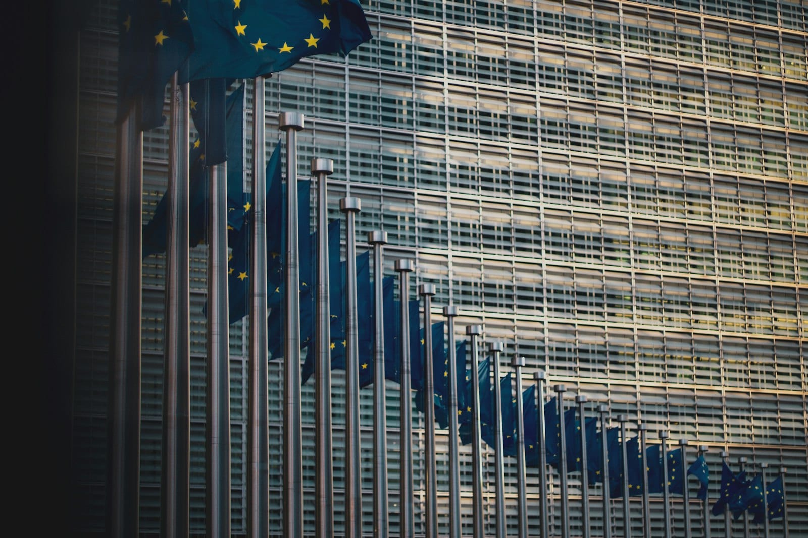 A row of European Union flags outside the European Commission building in Brussels